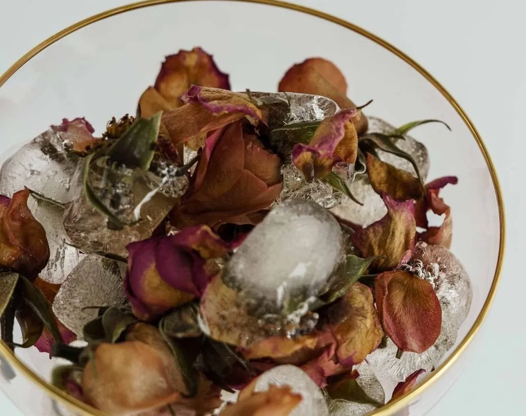 Dried rose buds in a clear glass bowl