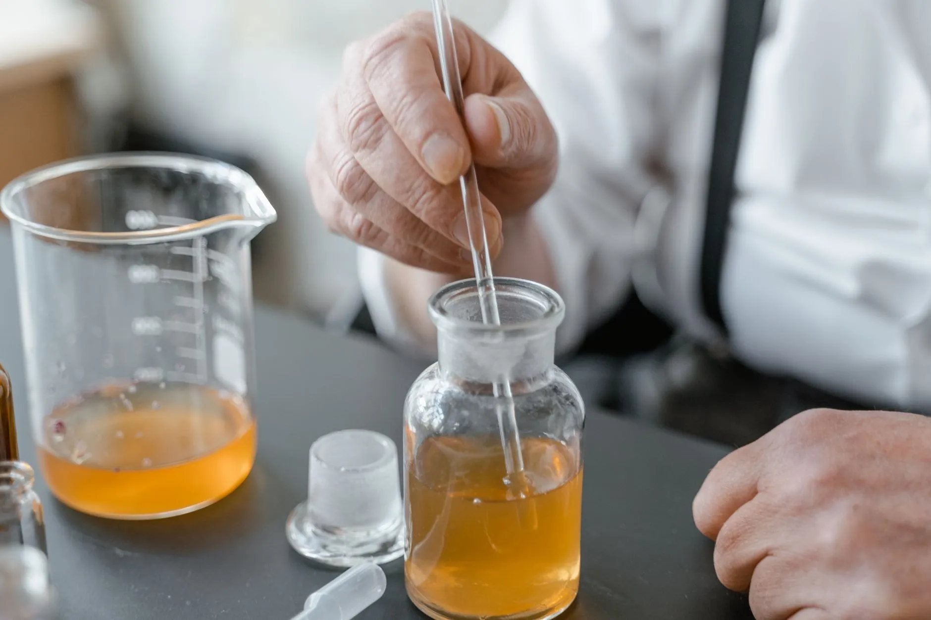 Every material is weighed to a hundredth of a gram, by hand, against the formula card.