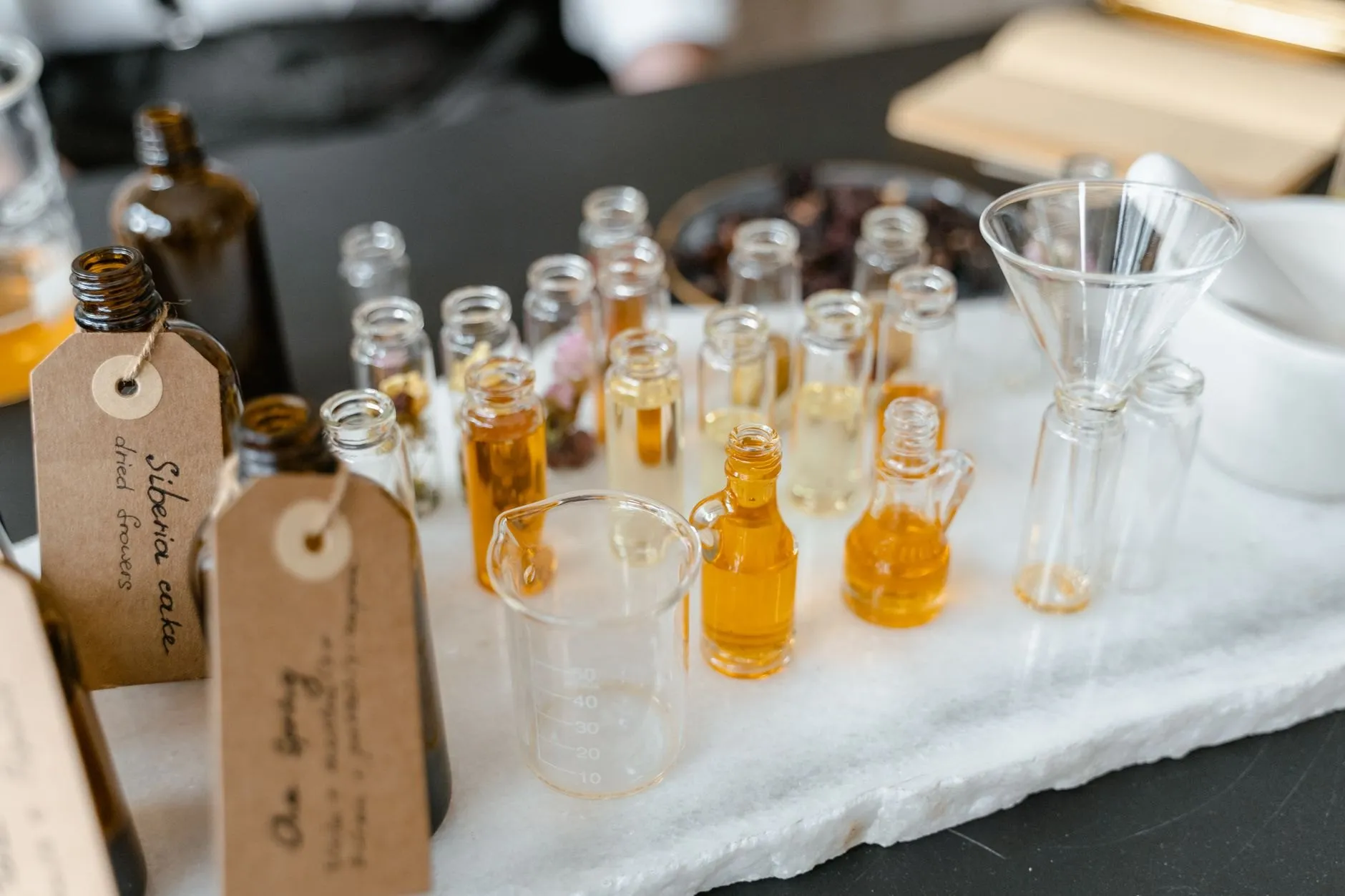 Bottles are filled, sealed and tagged with a handwritten batch number.